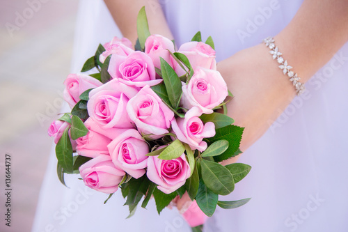 pink wedding bouquet in hands of bride