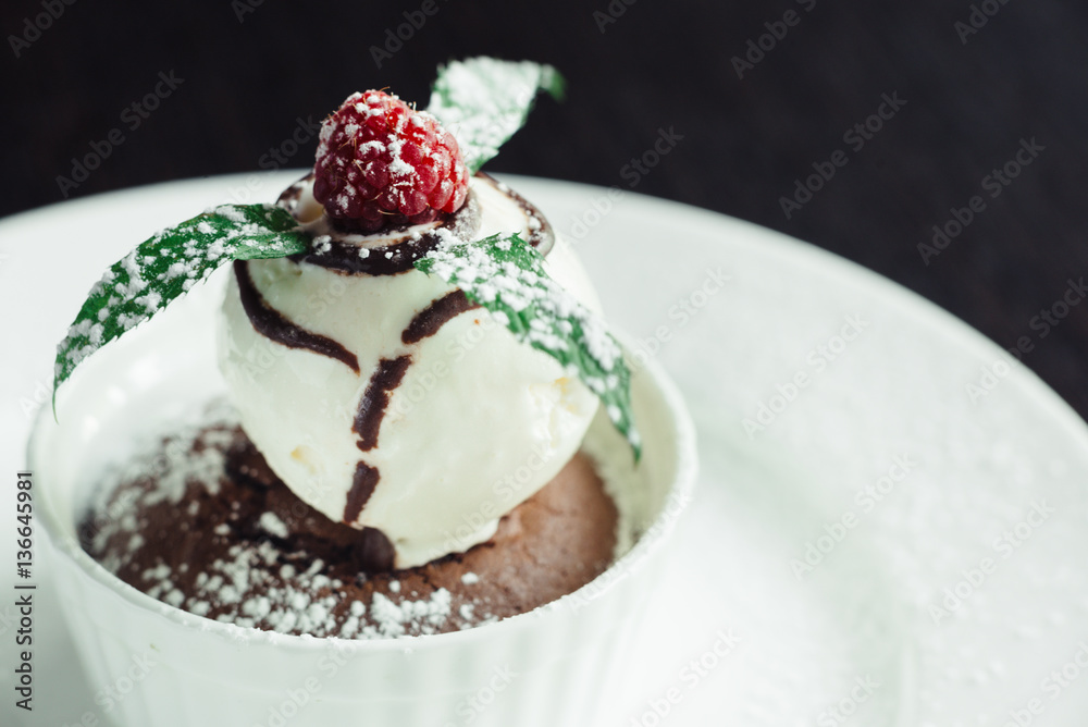 Cake chocolate Fondant with a scoop of ice cream on a white plate