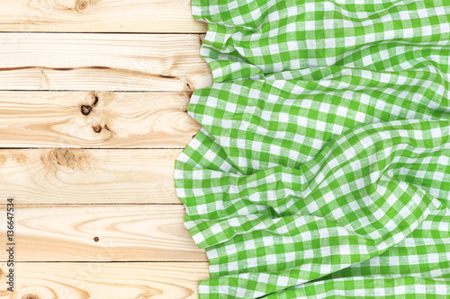 Green napkin on wooden table, top view