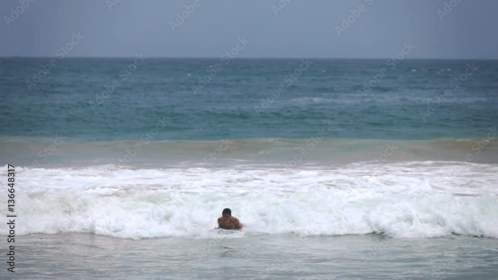 Teenage boy surfing on board in sea, super slow motion 240fps
Teenage boy surfing on board in sea, super slow motion 240fps