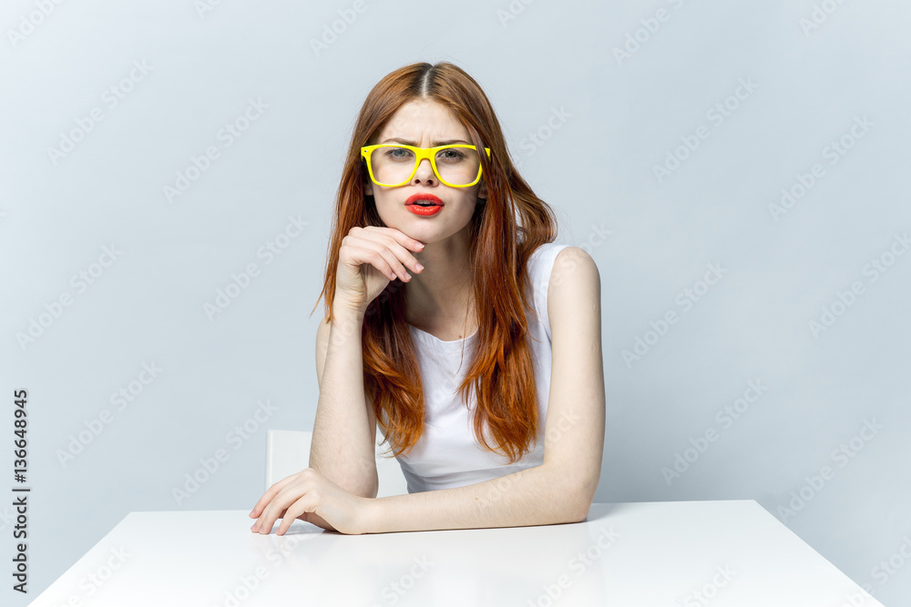 stylish woman in yellow glasses looks at the camera stylish woman in yellow glasses looks at the camera