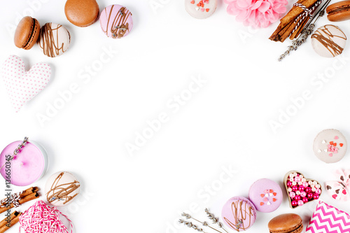 Holiday frame. Cake macaroon, hearts and romantic accessories with copy space.White background