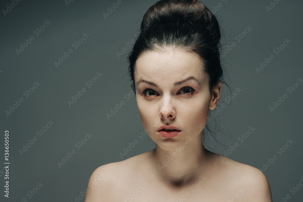gray background and surprised look of a brunette gray background and surprised look of a brunette