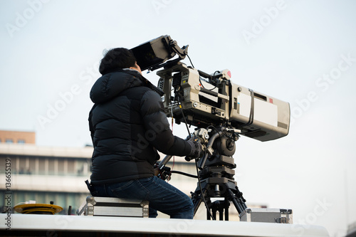 Operator with the TV camera on the roof of the building