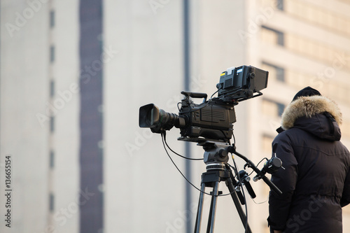 Operator with the TV camera on the roof of the building