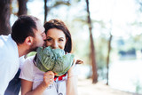 smiling pregnant couple with cabbage