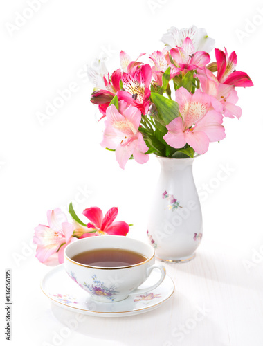 Still life with cup of tea and flowers (Alstroemeria)