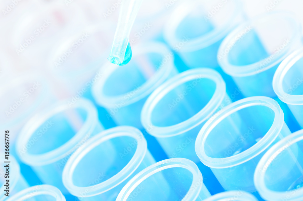 Blue laboratory chemical test tubes and pipette with drop Blue laboratory chemical test tubes and pipette with drop