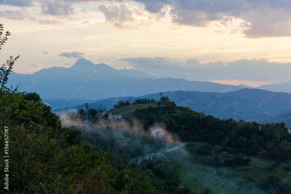 Fog on the Italian hills on a summer evening.