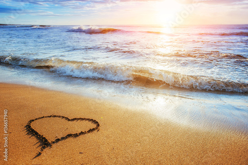 Heart on the sand beach. Romantic composition.
