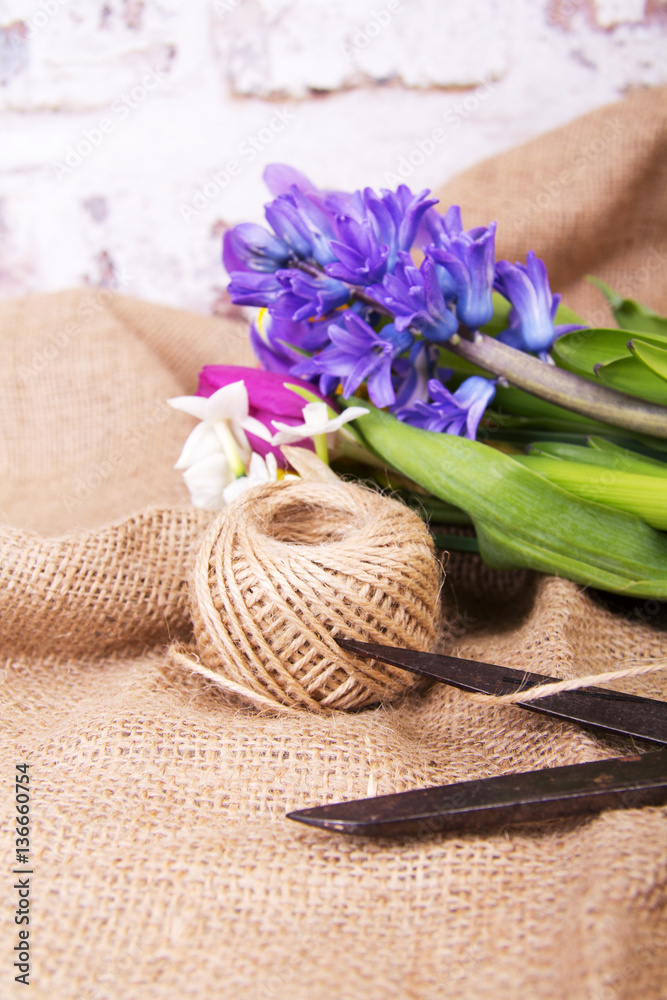 Spring flower arrangement against a rustic background Spring flower arrangement against a rustic background