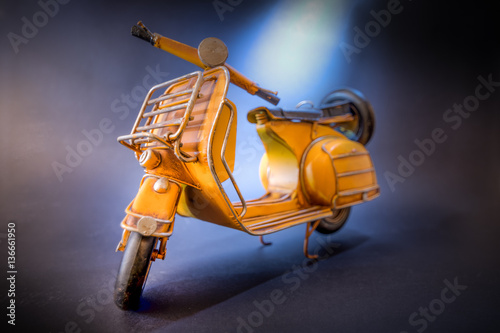Yellow miniature retro scooter motorcycle