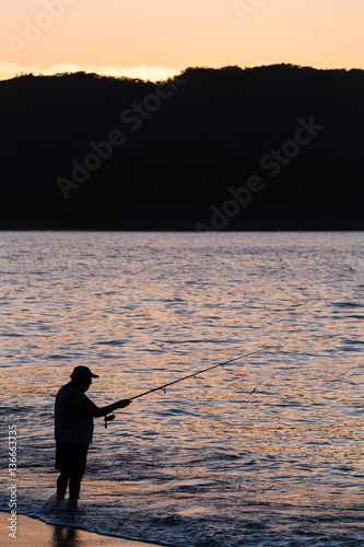 Silhouette of a tico fishing