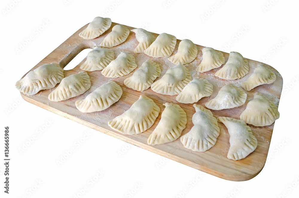 Dumplings in the flour on the cutting board Dumplings in the flour on the cutting board