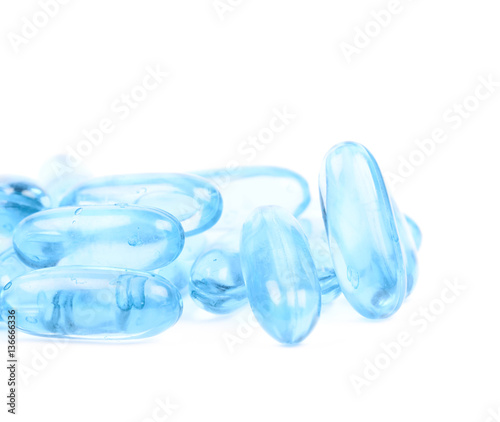 Pile of blue softgel pills isolated