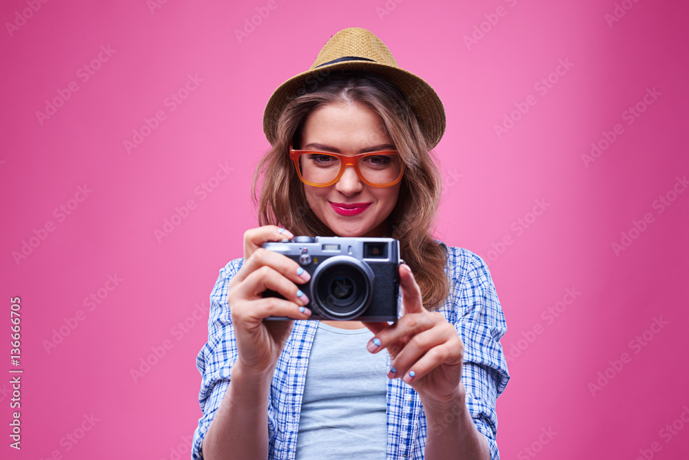 Trendy stylish girl using retro camera Trendy stylish girl using retro camera