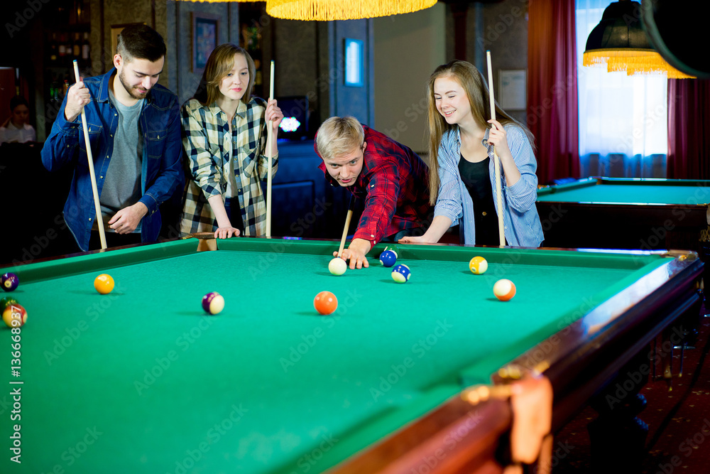 Fototapeta premium friends playing billiard