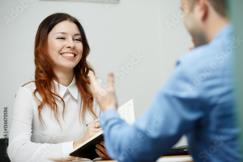 Happy business woman advises man