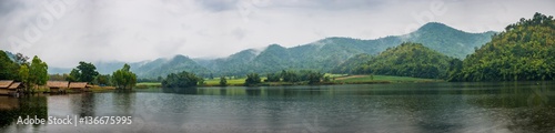 Beautiful tranquil lake and mountain covered with fog. Panorama