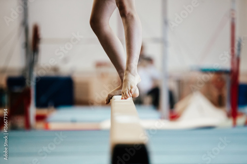 Fototapeta competition gymnastics exercises on balance beam girl gymnast