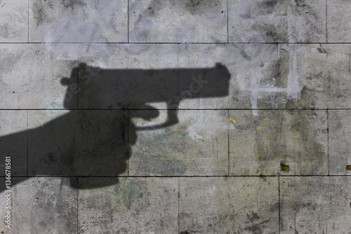 dark shadow of a hand holding a gun photo