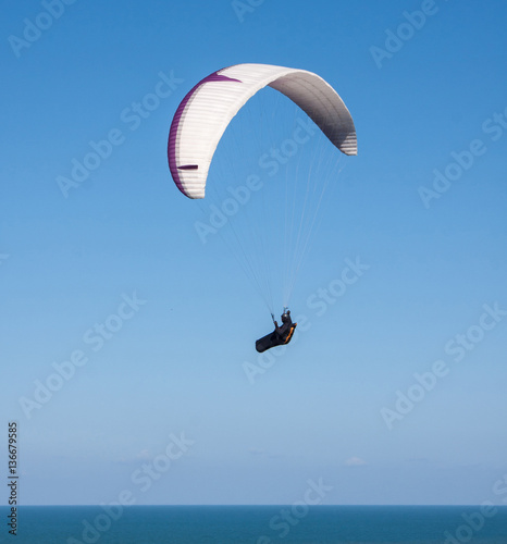 Paraglider soaring in the coastal upwinds somwhere in Queensland, Australia