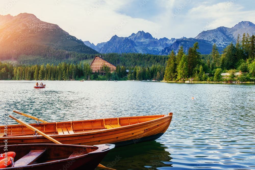 Boat on the dock surrounded mountains. Fantastic Shtrbske Pleso 