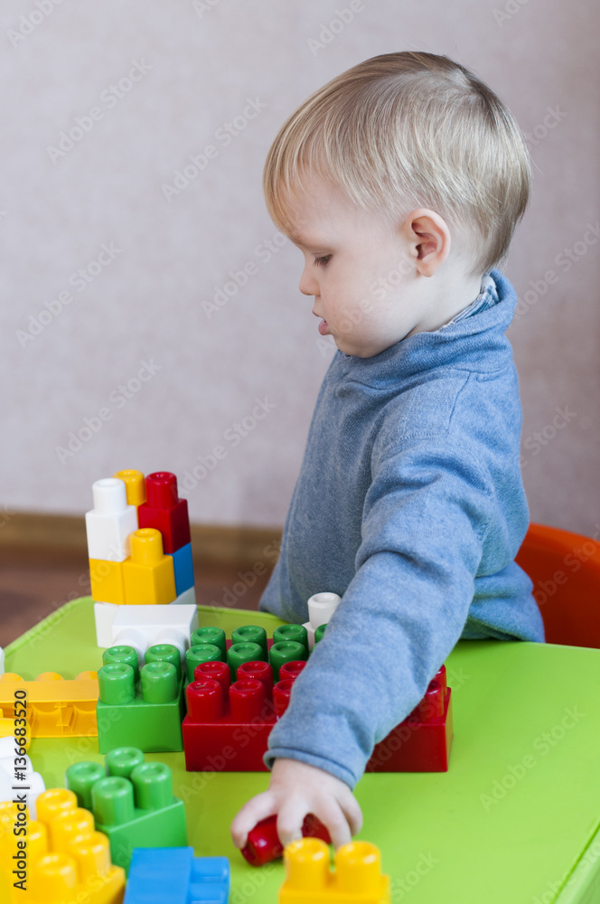 profile of a child playing with a toy constructor