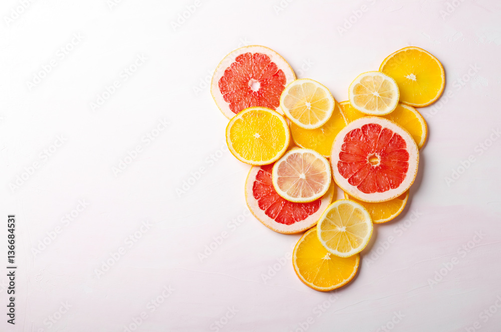 Citrus fruit Heart from slices of lemon, orange, grapefruit on white background. Love, healthy, ecology concept. Citrus fruit Heart from slices of lemon, orange, grapefruit on white background. Love, healthy, ecology concept.