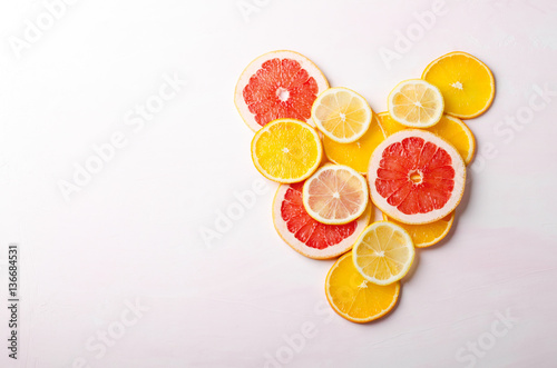 Citrus fruit Heart from slices of lemon  orange  grapefruit on white background. Love  healthy  ecology concept.