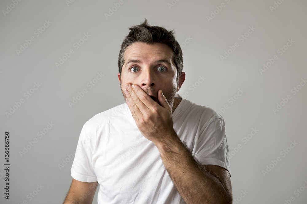 young attractive man astonished amazed in shock surprise face expression and shock emotion Stock