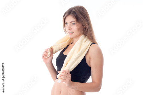 young fitness girl with towel on his shoulders is isolated a white background