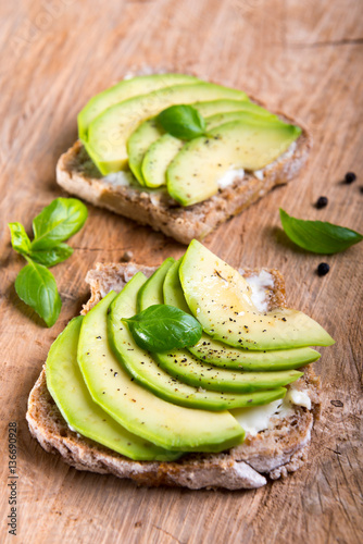 Sandwich with avocado slices and basil