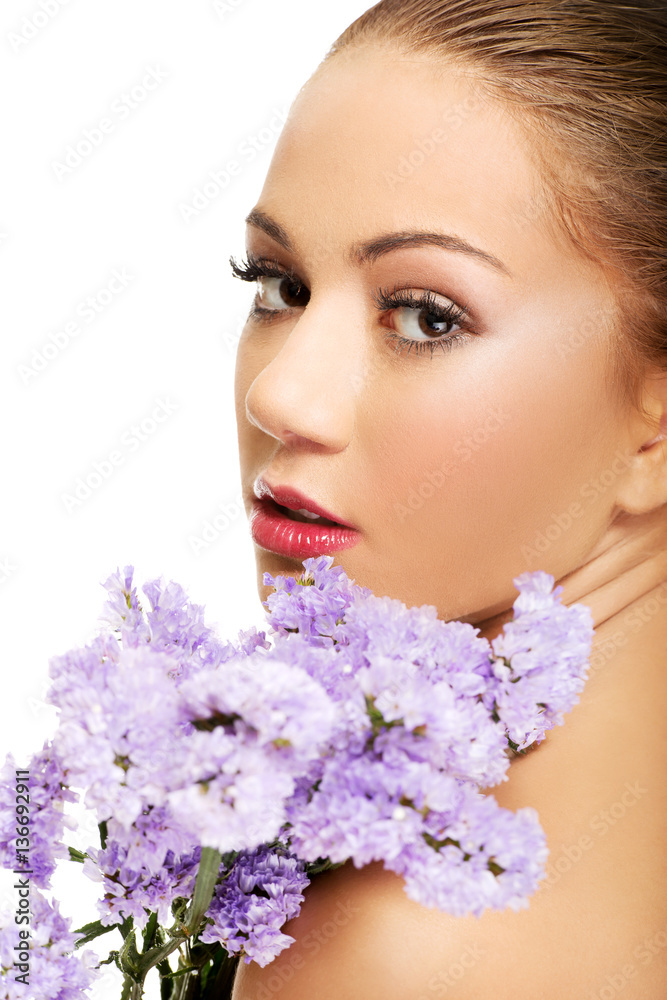 Sensual young spa woman holding flower. Sensual young spa woman holding flower.