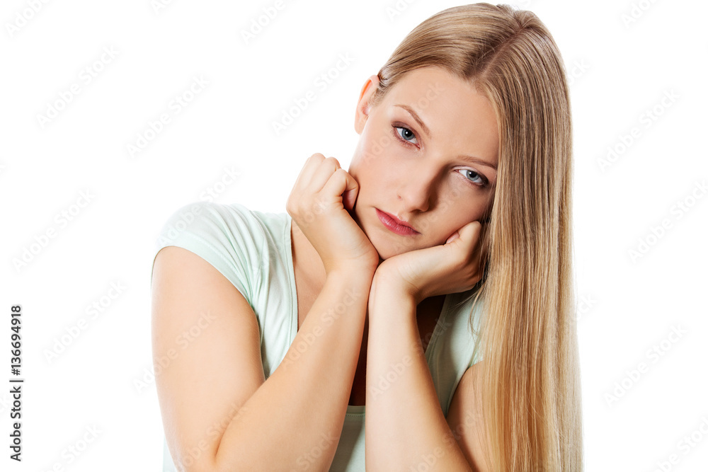 A young sad woman, isolated on white background. A young sad woman, isolated on white background.