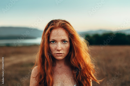 Portrait of redhead woman outdoors