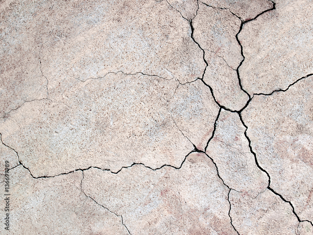 Fototapeta premium gray concrete wall with cracks texture as a background for desig