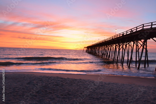 Fototapeta Naklejka Na Ścianę i Meble -  Sunrise over the pier in Kure Beach North Carolina