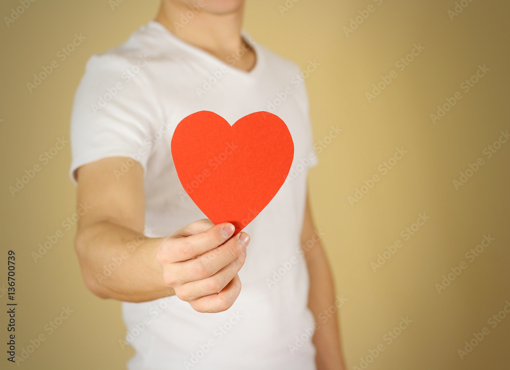 Man hands holding blank empty red Valentines card with heart on Man hands holding blank empty red Valentines card with heart on