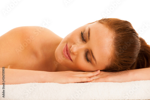 woman rests on white towel - conceptual photo for skin care and