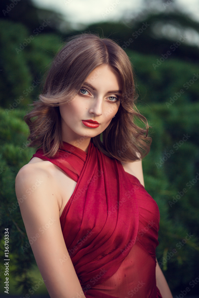Fashionable hair disheveled braid around the head .Happy beautiful young model girl in summer blossom park. Fashionable hair disheveled braid around the head .Happy beautiful young model girl in summer blossom park.