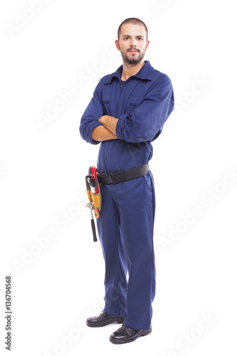 Young worker standing with arms crossed on white background - fu