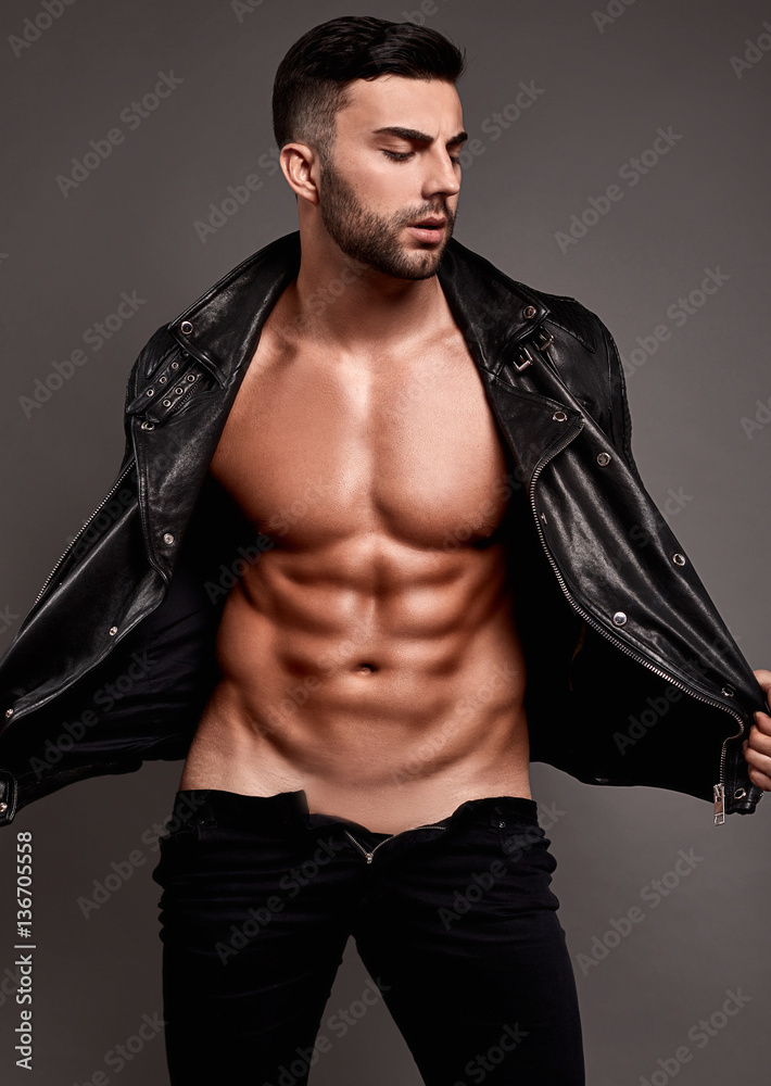 Muscular brutal handsome man in leather jacket
