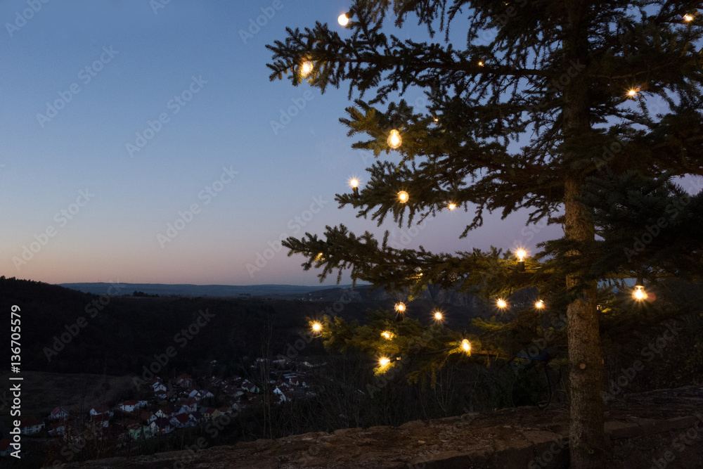 beleuchteter tannenbaum auf einem berg - obrazy, fototapety, plakaty 