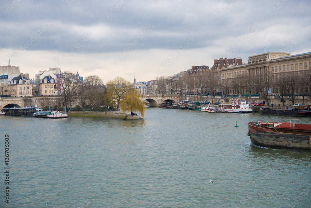     Paris, view of the Seine from the pont des Arts, with the Pont-Neuf and a barge crossing 
