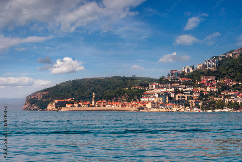 View of the town of Budva, sea bay and mountains distance in summertime. Montenegro. Balkans, Adriatic sea, Europe.