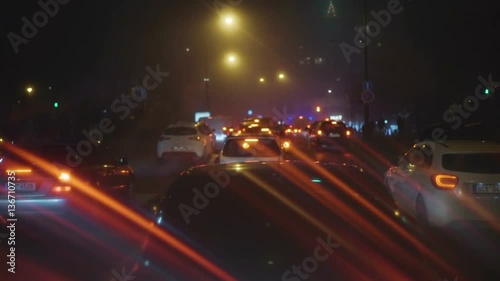 Road traffic in city at night. Shot is made with defocus.