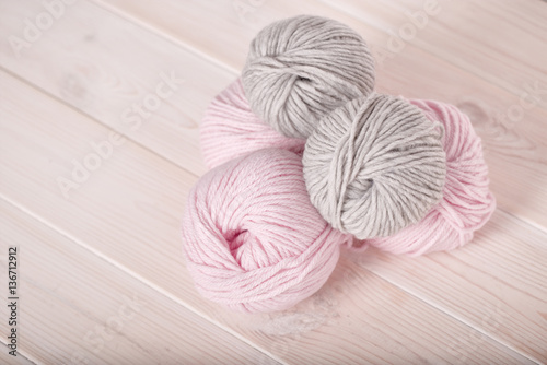 balls of wool pink and gray thread