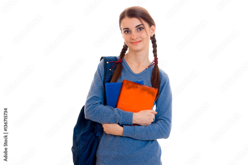 cheerful young student girl with backpack and books looking at the camera and smiling isolated on white background. student years concept. study concept. cheerful young student girl with backpack and books looking at the camera and smiling isolated on white background. student years concept. study concept.