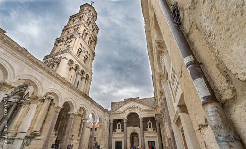 Split historic center cathedral view and toutists at dark claudy day.Diocletian palace UNESCO world heritage site in Split.